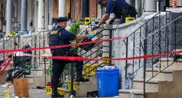 Crime scene investigators collecting evidence at a shooting scene.