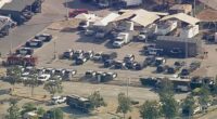 Aerial view of police and emergency vehicles at a scene.