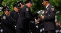 Throngs of police pay tribute to officer killed in New York office shooting
