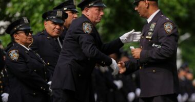 Throngs of police pay tribute to officer killed in New York office shooting