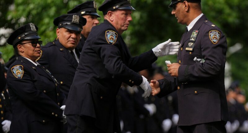 Throngs of police pay tribute to officer killed in New York office shooting