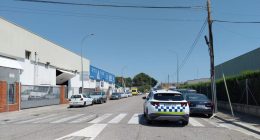 Street scene of parked cars near a police vehicle.