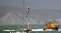 Lifeboat responding to a kite surfer incident near a yacht.