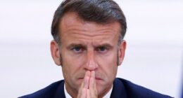 President Emmanuel Macron with hands clasped.