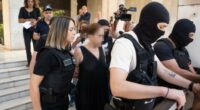 	Greek police lead the ex-wife of murdered UC Berkeley professor Przemyslaw Jeziorski to court in Athens on July 17, alongside her new boyfriend and three others alleged to be involved in the Polish educator's shooting on July 4. CNN has added blur to this image.