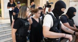 	Greek police lead the ex-wife of murdered UC Berkeley professor Przemyslaw Jeziorski to court in Athens on July 17, alongside her new boyfriend and three others alleged to be involved in the Polish educator's shooting on July 4. CNN has added blur to this image.