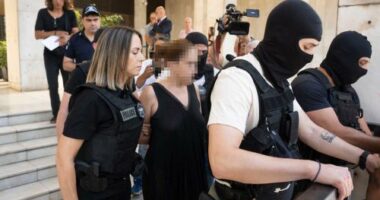 	Greek police lead the ex-wife of murdered UC Berkeley professor Przemyslaw Jeziorski to court in Athens on July 17, alongside her new boyfriend and three others alleged to be involved in the Polish educator's shooting on July 4. CNN has added blur to this image.
