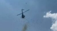 Helicopter dropping cash from the sky.