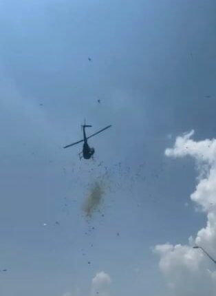 Helicopter dropping cash from the sky.