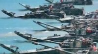 Military amphibious vehicles in the water.