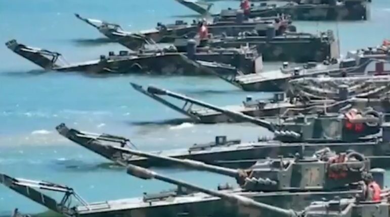 Military amphibious vehicles in the water.