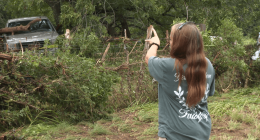 Leander woman shows the tree she climbed to survive floods during the early morning hours of July 5, 202