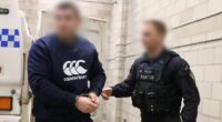 Rebels bikie charged over video of caged cat being shot at point blank