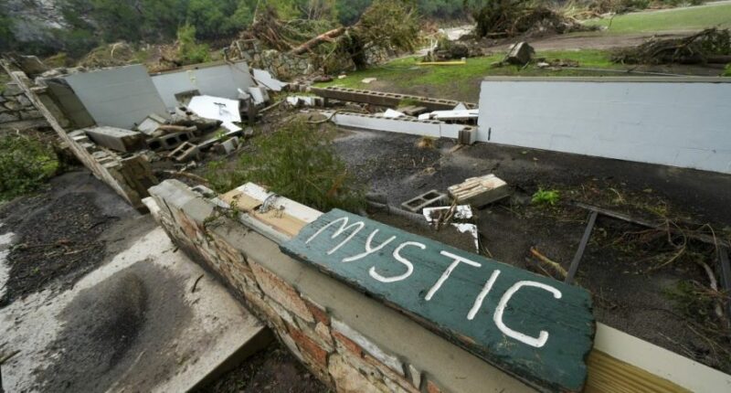 A Camp Mystic sign is seen near the entrance to the establishment along the banks of the Guadalupe River in Hunt, Texas, Saturday, July 5, 2025, after a flash flood swept through the area. (AP Photo/Julio Cortez)