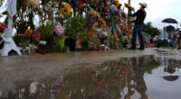 Roberto Marquez places a cross at a memorial wall for flood victims, Sunday, July 13, 2025, in Kerrville, Texas. (AP Photo/Eric Gay)