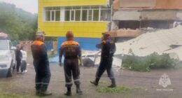 Emergency personnel at a kindergarten damaged by an earthquake.