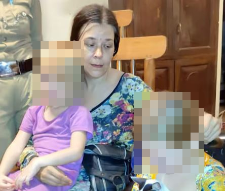 Woman holding two children.