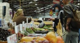 General photo of people shopping for fruits and vegetables at the Queen Vic Market.