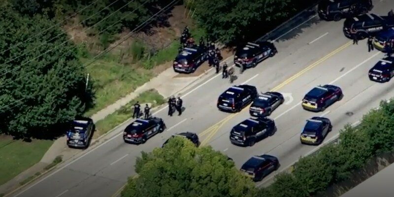 Aerial view of police cars and officers responding to an active shooter near Emory University.