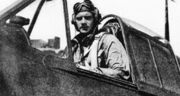Black and white photo of Donald McPherson, America's last living ace pilot from World War II, in the cockpit of his plane.