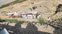 Bus crash scene with rescue workers.