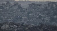 Buildings that were destroyed during the Israeli ground and air operations stand in the northern Gaza Strip as seen from southern Israel, Friday, Aug. 8, 2025. (AP Photo/Leo Correa)