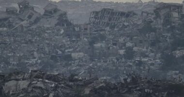 Buildings that were destroyed during the Israeli ground and air operations stand in the northern Gaza Strip as seen from southern Israel, Friday, Aug. 8, 2025. (AP Photo/Leo Correa)
