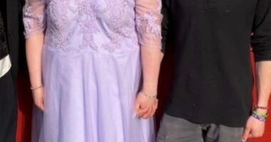Screenshot of a couple posing for a photo.