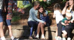 Parents comforting children after a school shooting.