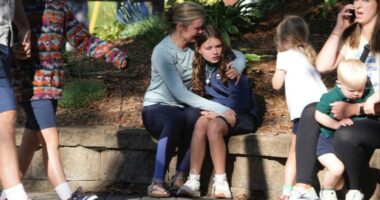 Parents comforting children after a school shooting.