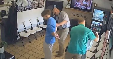 Chilling moment murder suspect is arrested while having his hair cut