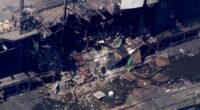 Aerial view of a damaged industrial building.
