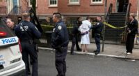Police officers arresting a man in a bathrobe.
