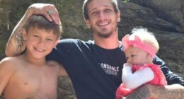Photo of a father with his two young children.