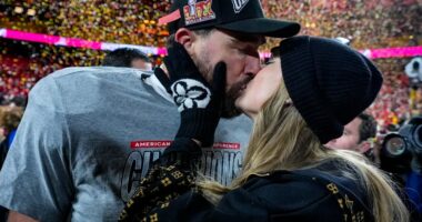 Travis Kelce and Taylor Swift kissing after an AFC Championship game.