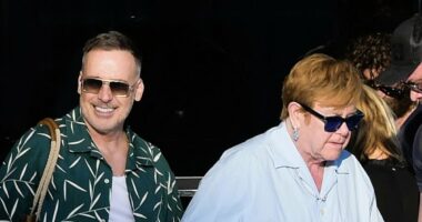 Elton John holds hands with husband David Furnish