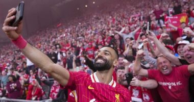 Liverpool's Mohamed Salah celebrates by taking a selfie after winning the English Premier League soccer match between Liverpool and Tottenham Hotspur and clinching the Premier League title at Anfield in Liverpool, England, Sunday, April 27, 2025. (AP Photo/Jon Super)