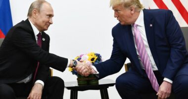 Presidents Putin and Trump shaking hands at a meeting.