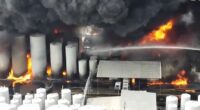 Large fire engulfing storage tanks.