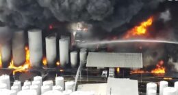 Large fire engulfing storage tanks.