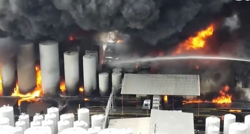 Large fire engulfing storage tanks.
