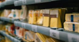 Variety of cheese on supermarket shelves.