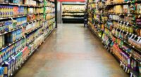 Grocery store aisle with shelves stocked with food.
