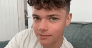 Photo of a young man with curly hair.
