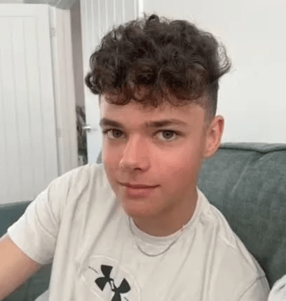 Photo of a young man with curly hair.
