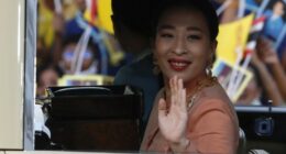 Princess Bajrakitiyabha Mahidol waving from a car.