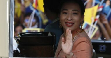 Princess Bajrakitiyabha Mahidol waving from a car.