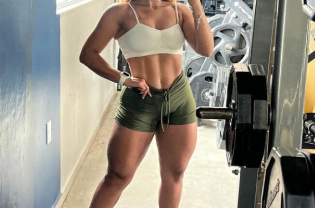Woman taking a selfie in a gym.