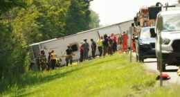 First responders work to rescue victims at the scene of a tour bus that crashed and rolled over on the New York State Thruway.