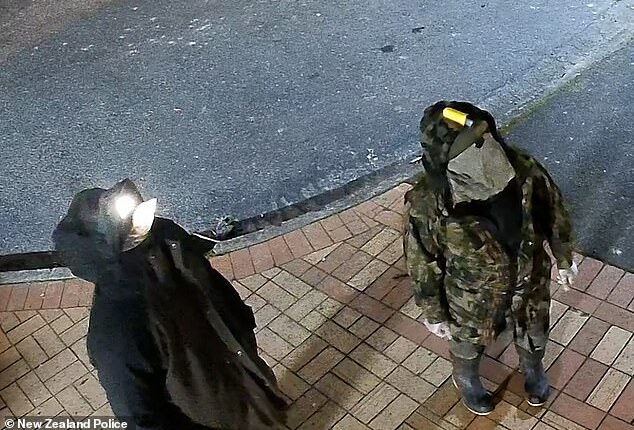 A fugitive dad who vanished into the New Zealand wilderness with his three young children has been caught on camera for the first time in a year breaking into a convenience store with one of his kids